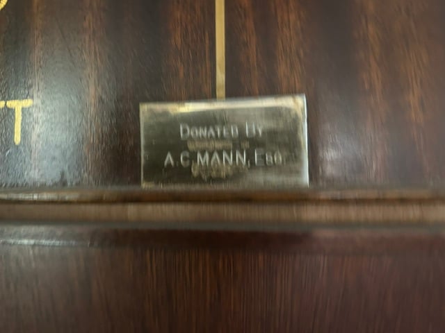 Brass plate reading Donated by A. C. Mann, Esq