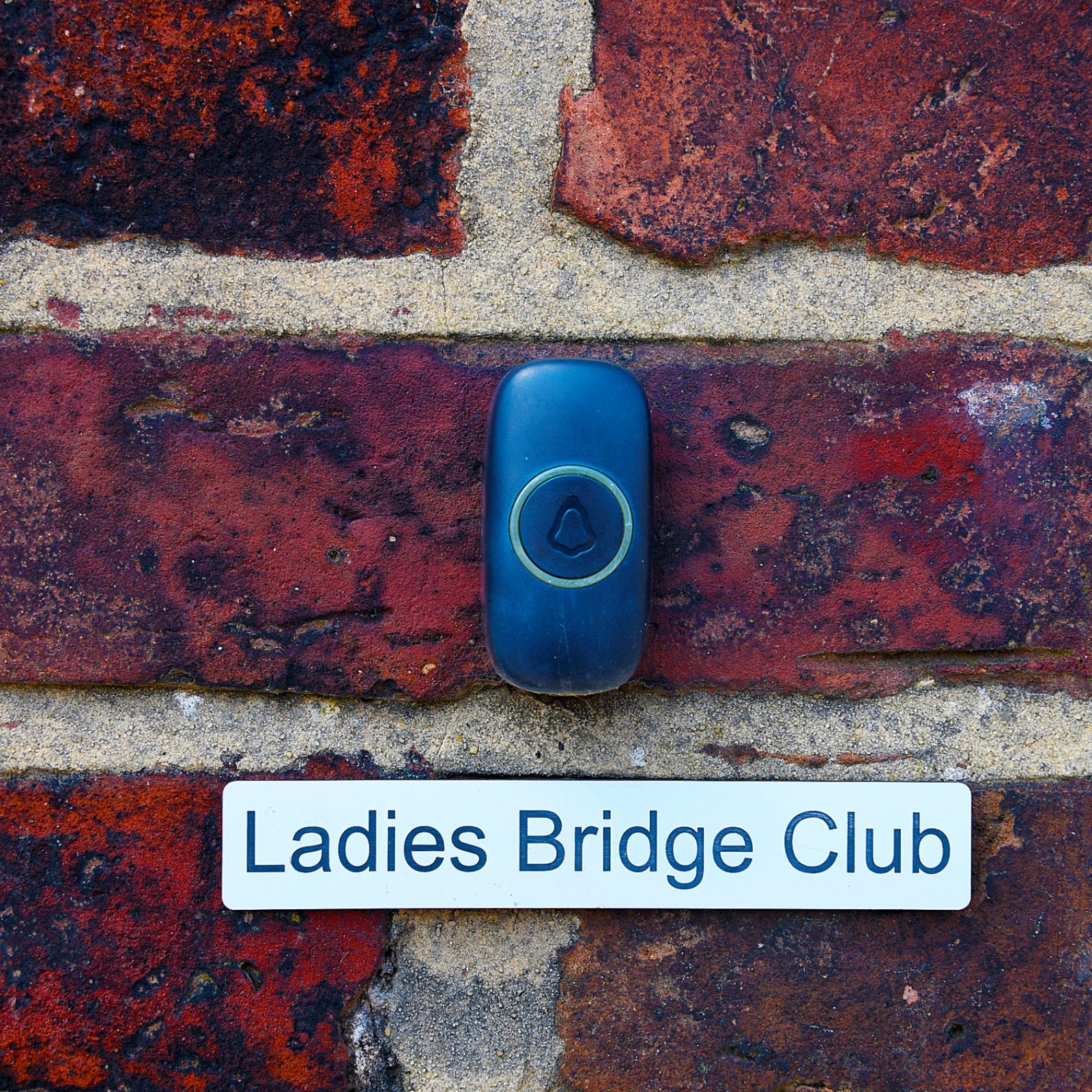 The Ladies Bridge Club doorbell on the club's brick wall