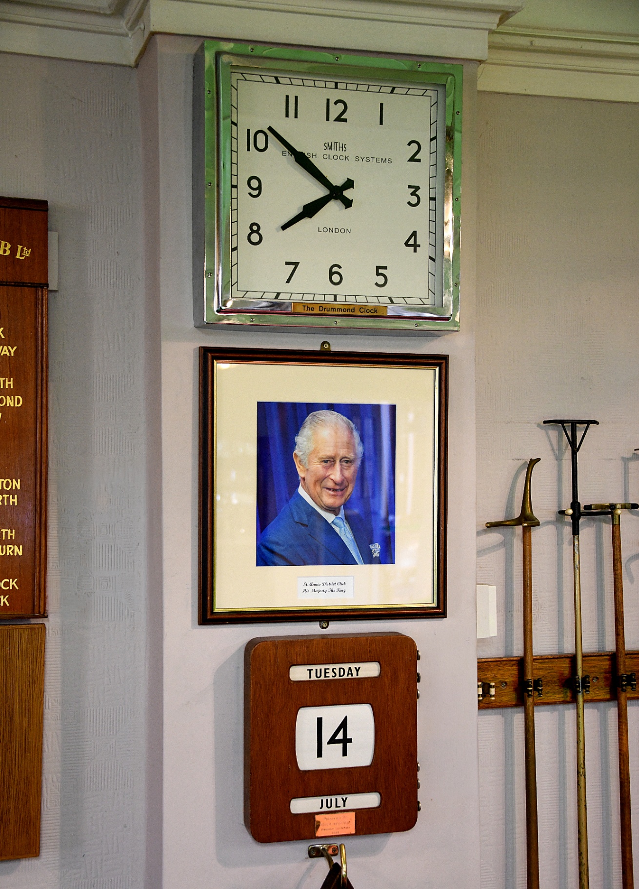The club's honours boards, brass-gold names lettered on dark walnut panels.