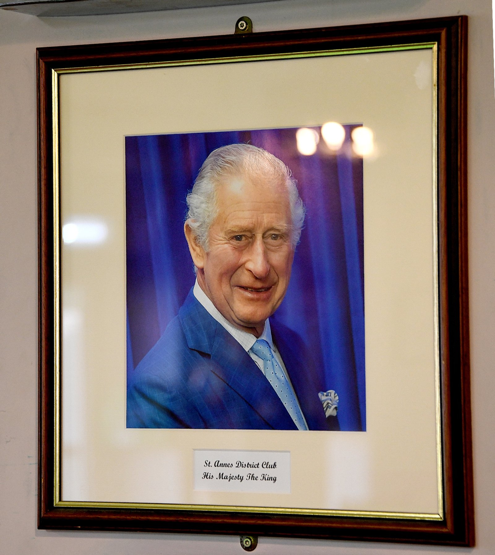 A framed portrait wall inside the club, showing the succession of past officers.