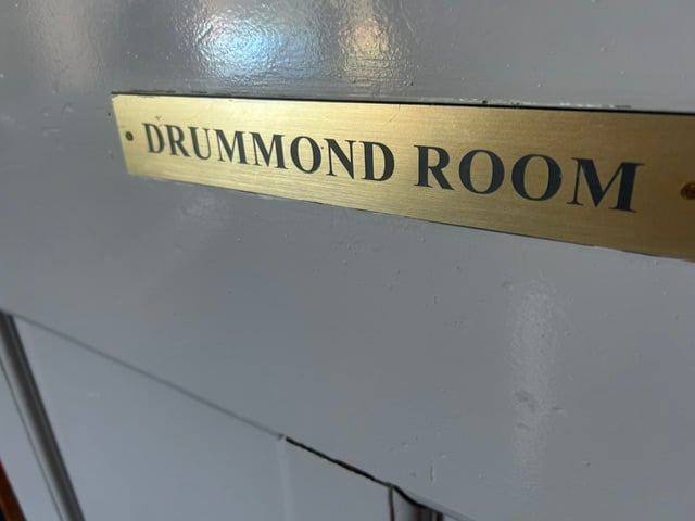 Brass door plate reading Drummond Room