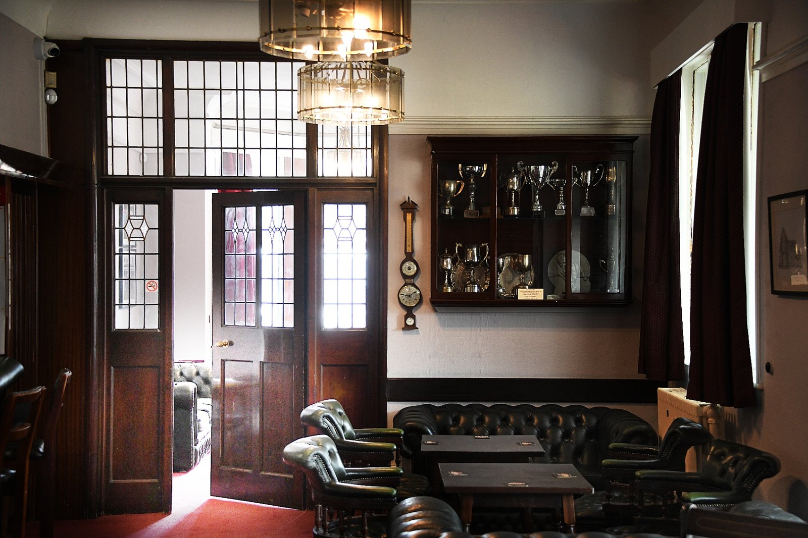 The club lounge, with the trophy cabinet and barometer