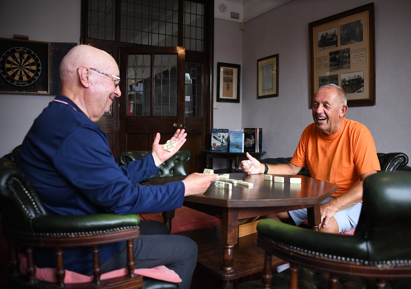 Two members playing dominoes in the club lounge